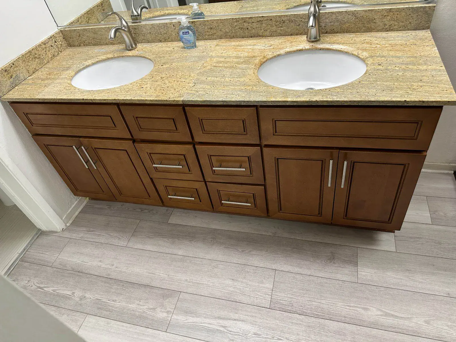 Spotless double-sink granite bathroom vanity with shining chrome fixtures