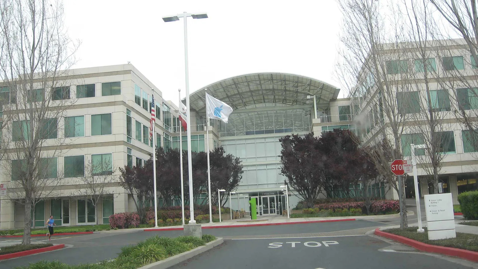 Corporate office campus entrance with flags, used for Cupertino service area