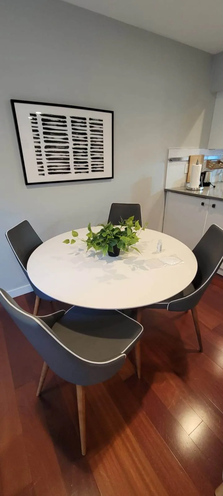 Clean dining table and chairs set with hand sanitizer for guests