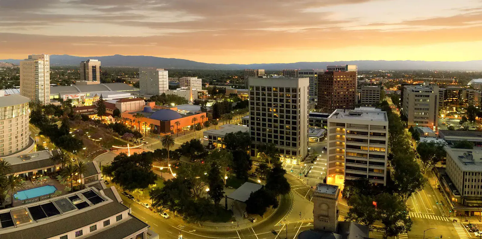 Aerial dusk skyline view of downtown San Jose with lit high-rises