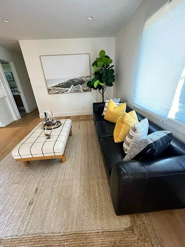 black couch, yellow pillows