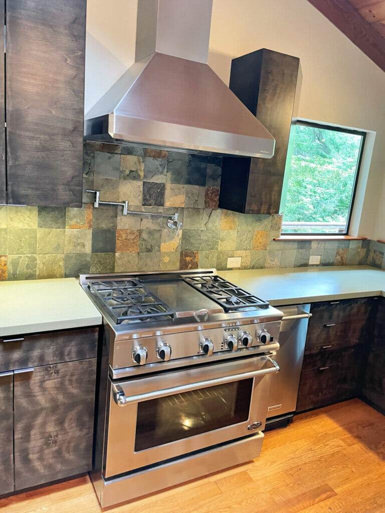 A stainless steel range hood in a kitchen, master clean.