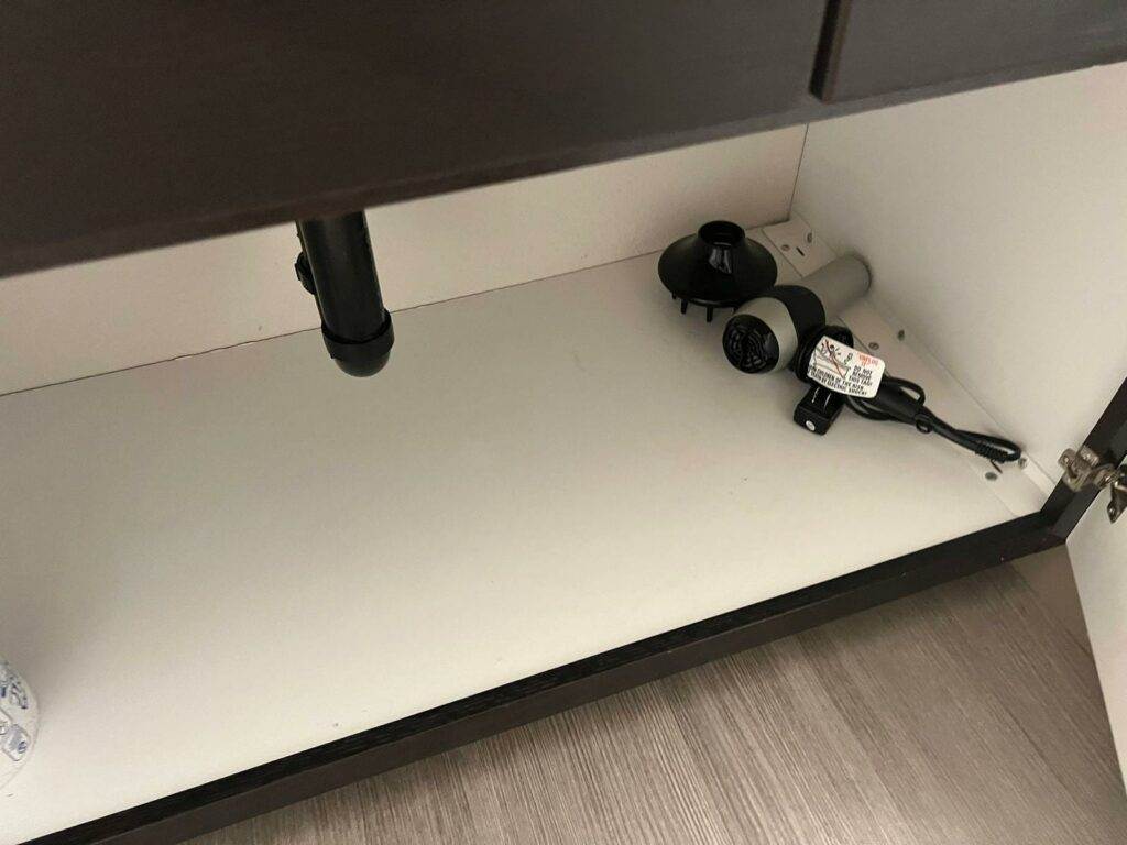 A sink with a faucet under it, integrated with kitchen cabinets.