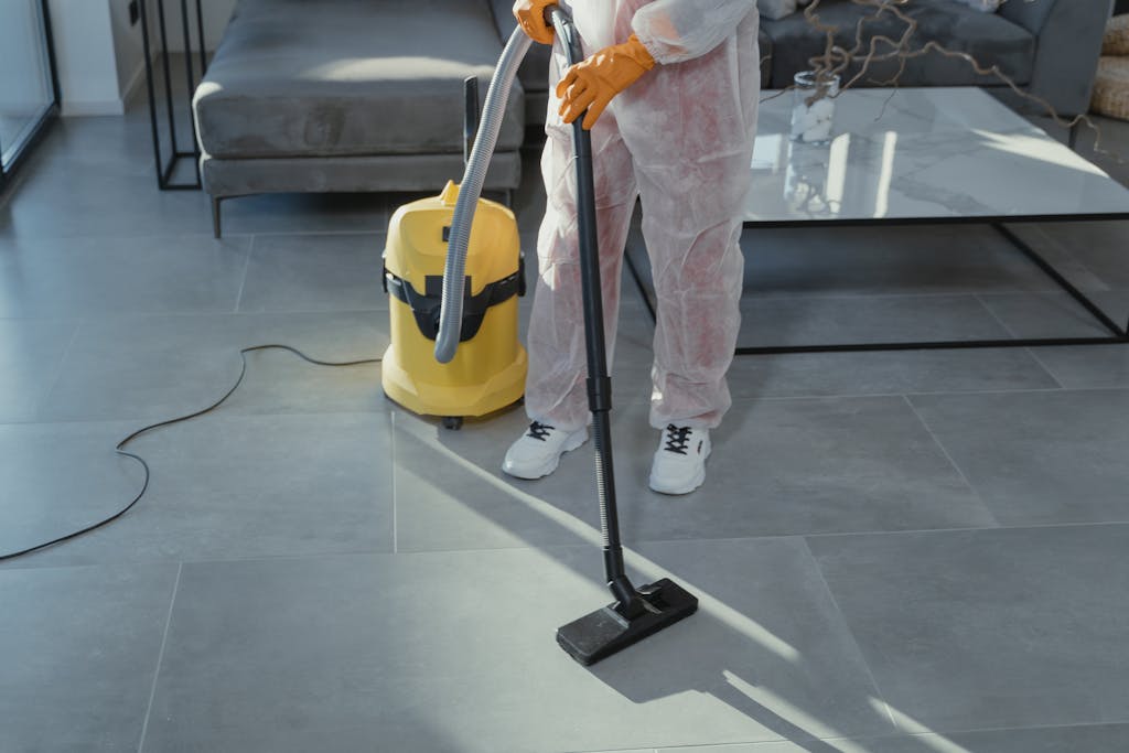 A Close-Up Shot of a Person Using a Vacuum Cleaner