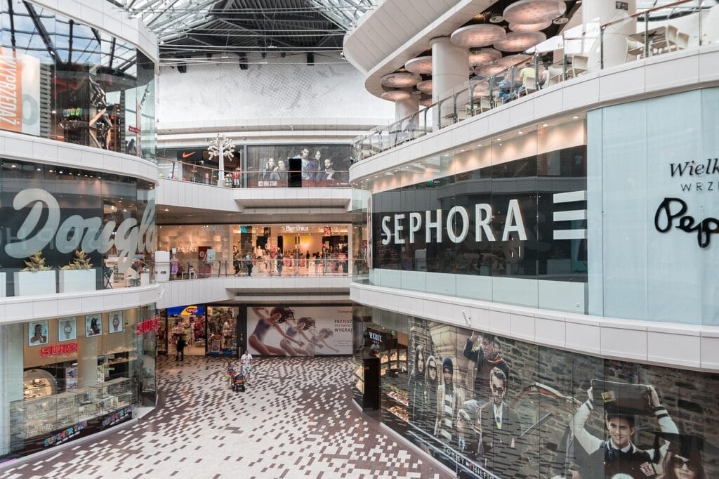 Interior view of a modern shopping mall in San Jose with multiple floors, featuring large Sephora and Douglas store signs, smaller shops, and pristine spaces after expert final cleaning—ready for jobsite turnover.